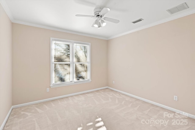 unfurnished room featuring light carpet, ceiling fan, and crown molding