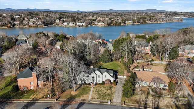 birds eye view of property with a water and mountain view