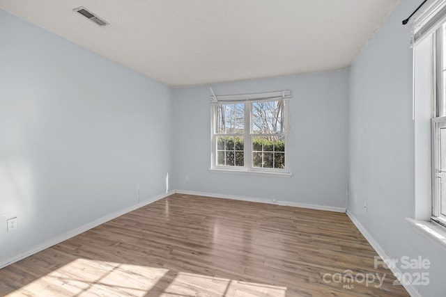 spare room featuring light hardwood / wood-style flooring