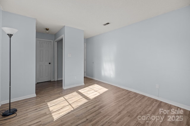 unfurnished room featuring light hardwood / wood-style floors