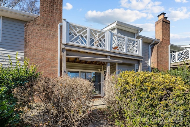 view of home's exterior with a balcony