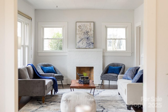 sitting room with wood-type flooring and a brick fireplace