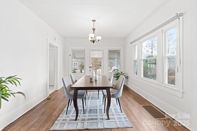 sunroom with a chandelier