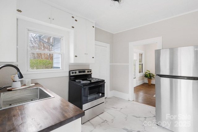 kitchen featuring white cabinetry, appliances with stainless steel finishes, and sink