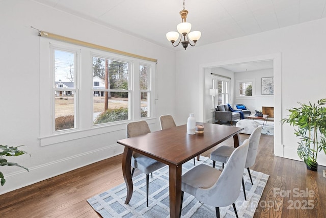 dining space featuring dark hardwood / wood-style flooring and a notable chandelier