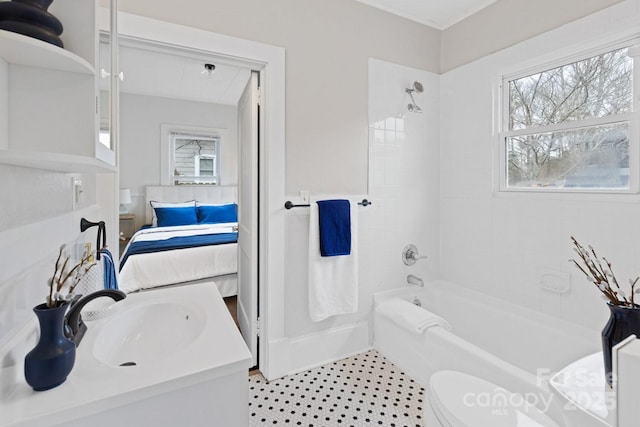 full bathroom featuring toilet, tiled shower / bath combo, and sink