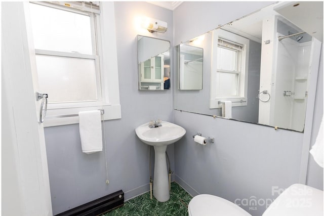 bathroom featuring toilet and walk in shower