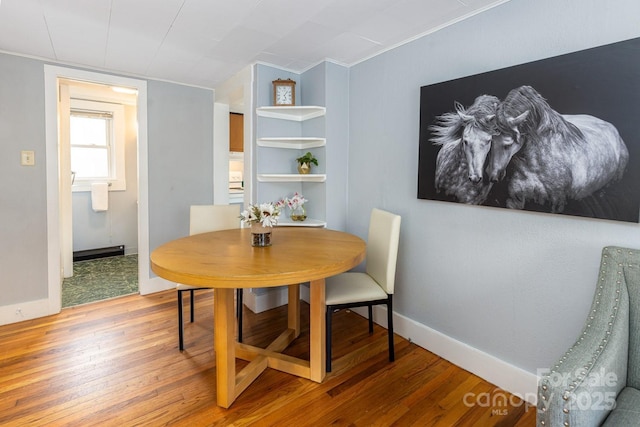 dining space featuring hardwood / wood-style floors