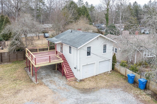 exterior space with a garage and a deck