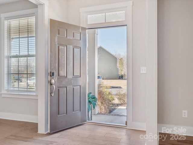 entrance foyer with plenty of natural light and light wood-type flooring