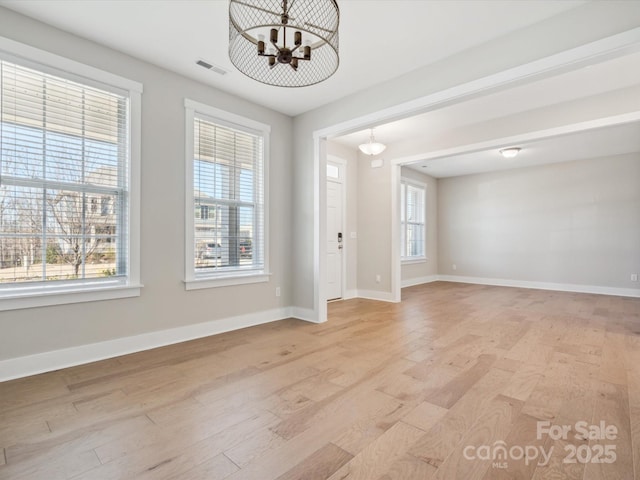 interior space with light hardwood / wood-style floors and a chandelier