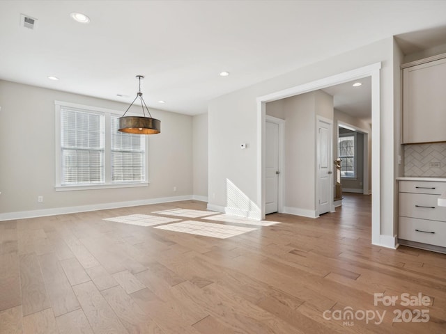 unfurnished dining area featuring light hardwood / wood-style flooring