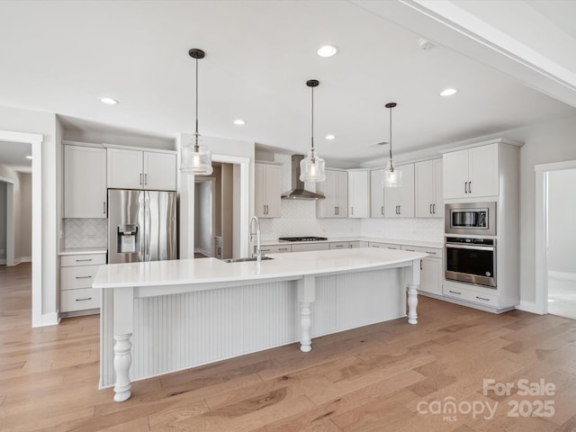 kitchen featuring white cabinetry, sink, a kitchen island with sink, and appliances with stainless steel finishes