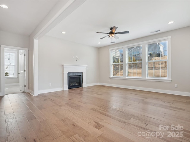 unfurnished living room with ceiling fan and light wood-type flooring