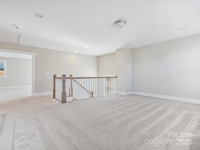 unfurnished room featuring light carpet