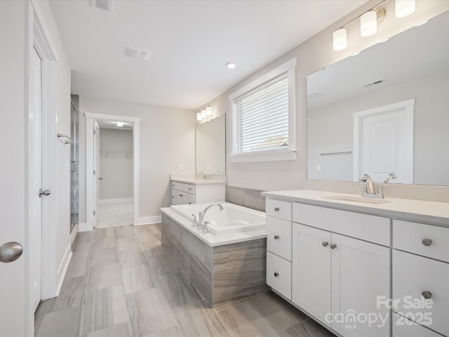 bathroom featuring separate shower and tub and vanity