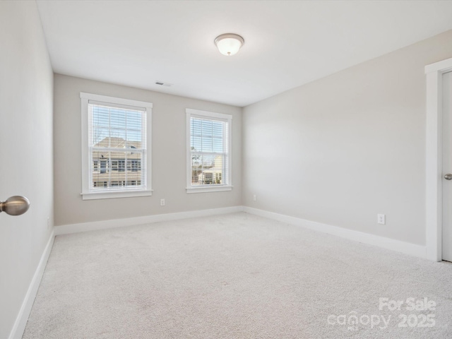 empty room featuring light carpet