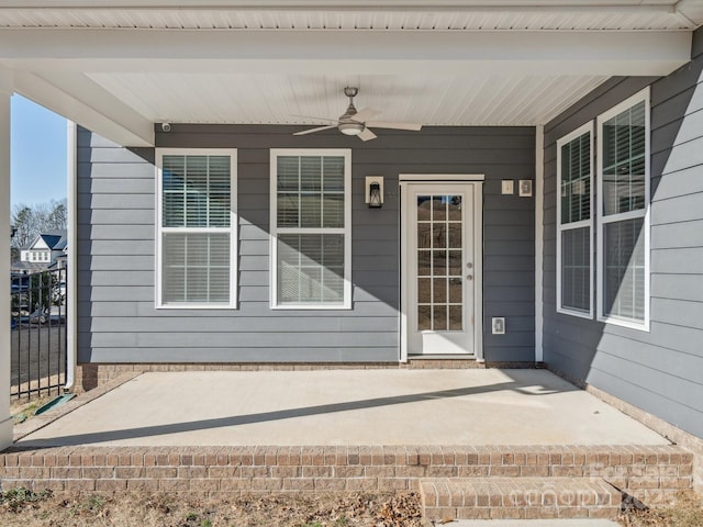 entrance to property with a porch and ceiling fan