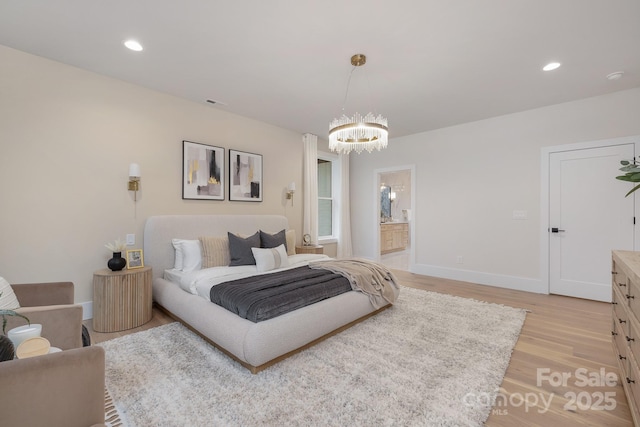 bedroom featuring a notable chandelier, recessed lighting, ensuite bathroom, light wood-style floors, and baseboards