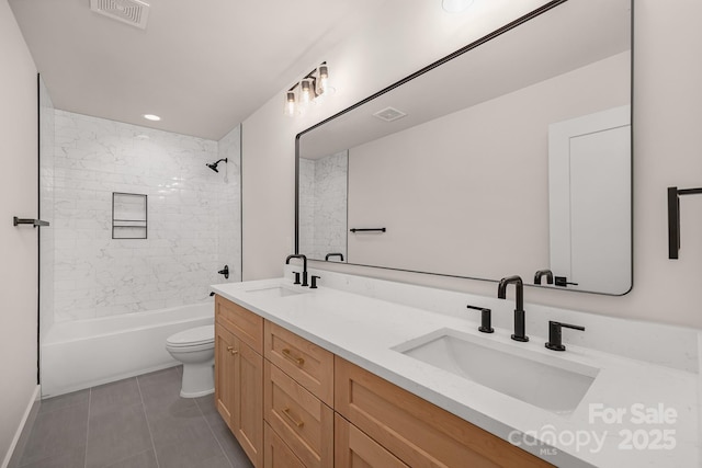 bathroom featuring double vanity, a sink, and visible vents