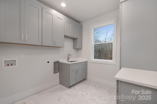 laundry area featuring cabinet space, a sink, marble finish floor, washer hookup, and electric dryer hookup