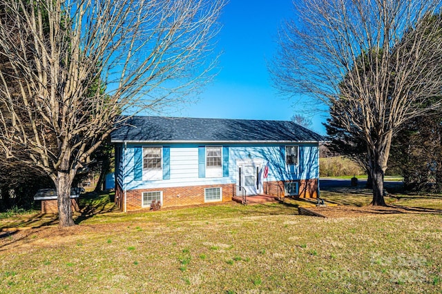 raised ranch featuring a front lawn