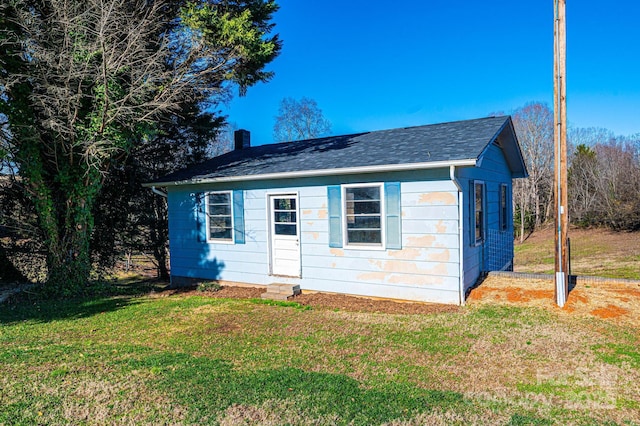 view of outbuilding featuring a yard