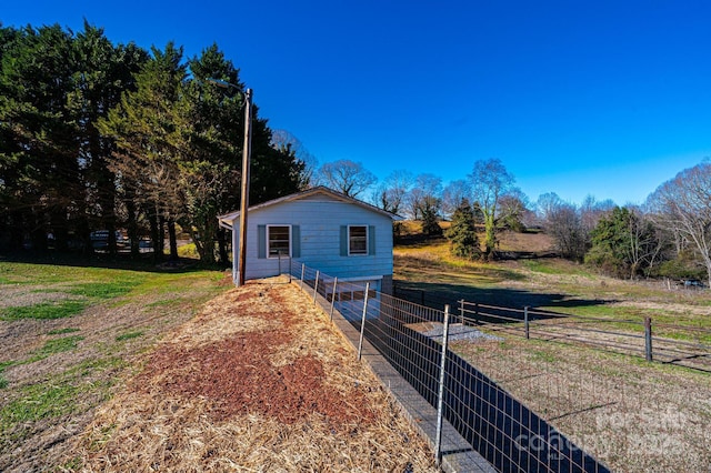 view of side of home featuring a rural view