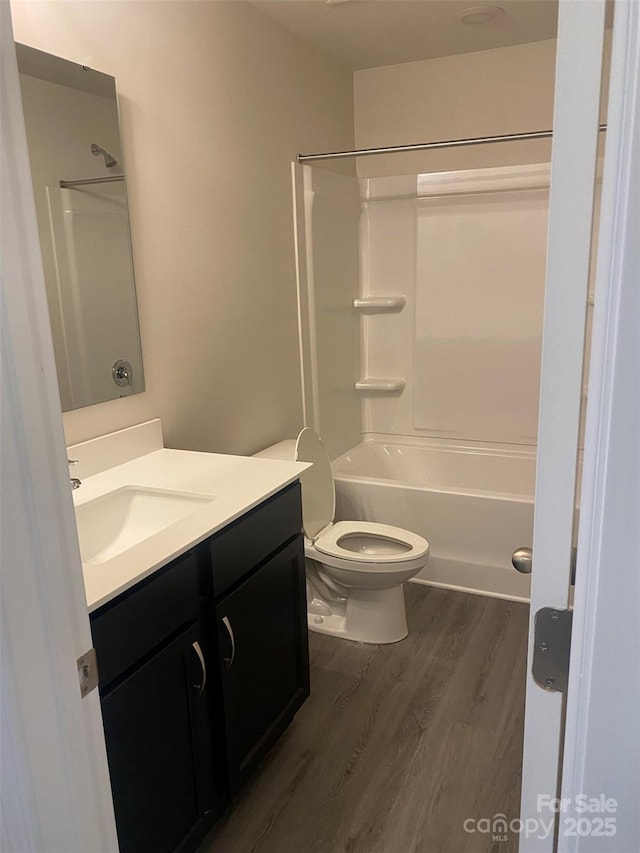 full bathroom with wood-type flooring, vanity, toilet, and shower / bathtub combination