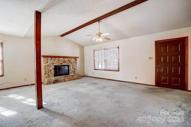 unfurnished living room featuring ceiling fan, light colored carpet, lofted ceiling with beams, and a fireplace