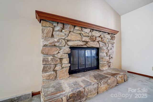 details with carpet and a stone fireplace