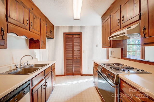 kitchen featuring a textured ceiling, appliances with stainless steel finishes, and sink