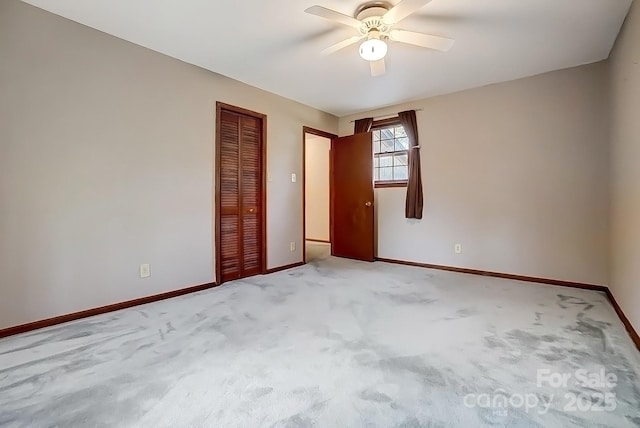 unfurnished room featuring ceiling fan and carpet flooring