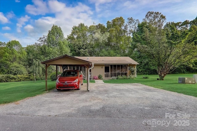 view of front of property with a front yard and a carport