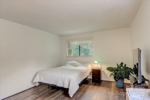 bedroom featuring dark hardwood / wood-style floors