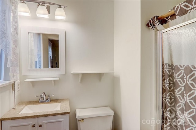 bathroom with a shower with curtain, toilet, and vanity