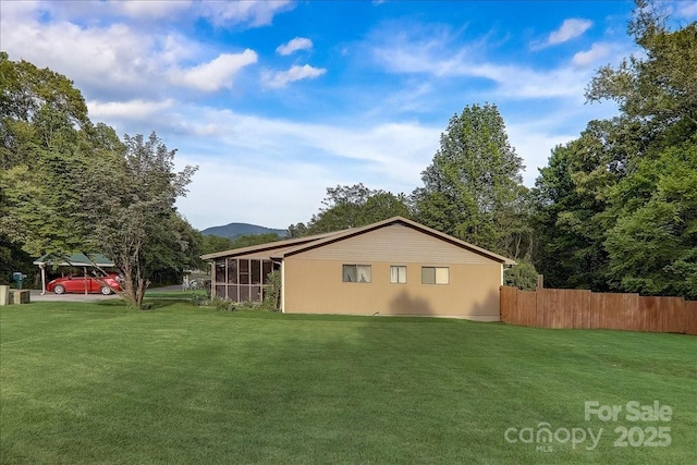 view of side of home with a yard