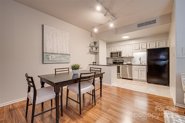 dining room featuring light hardwood / wood-style floors and sink