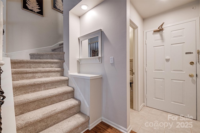 stairs featuring tile patterned flooring