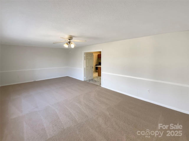 empty room featuring carpet, a textured ceiling, and ceiling fan