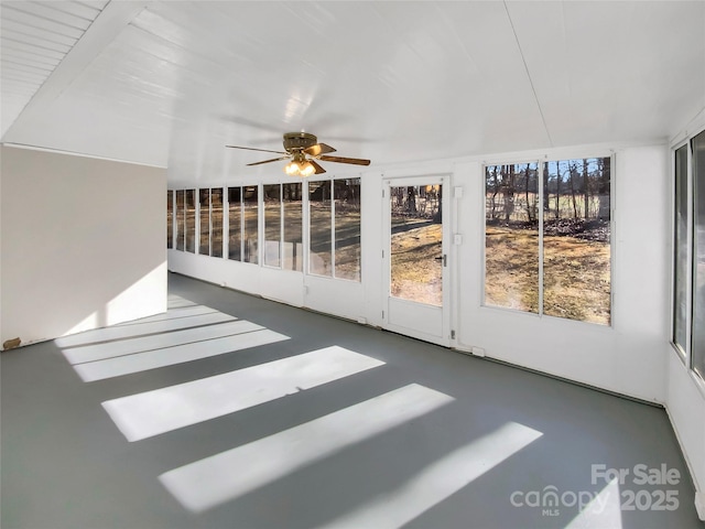 unfurnished sunroom featuring ceiling fan