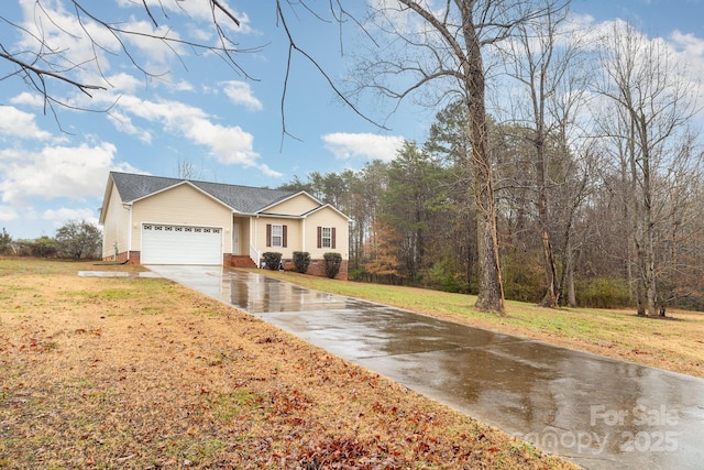 view of front of home featuring a garage and a front lawn