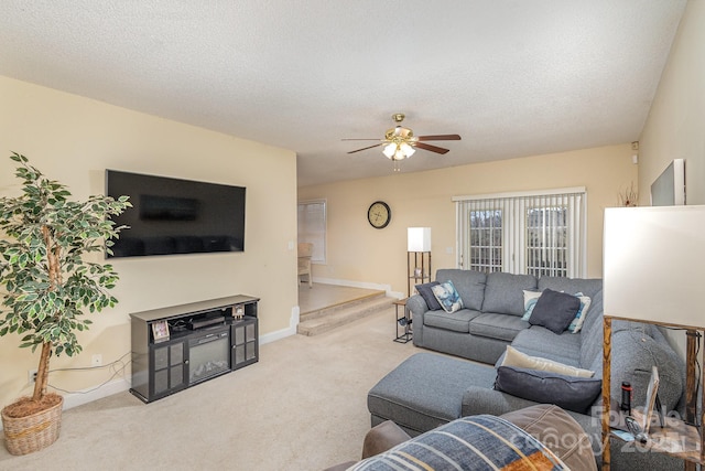 carpeted living room with ceiling fan and a textured ceiling