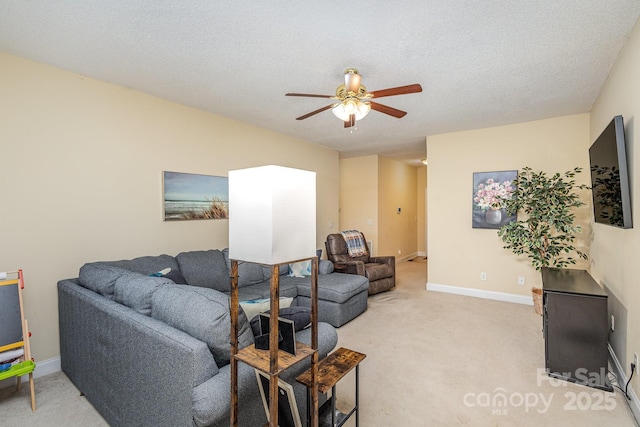 living room with carpet, ceiling fan, and a textured ceiling