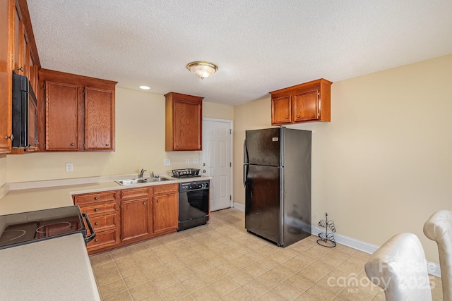 kitchen featuring a textured ceiling, sink, and black appliances