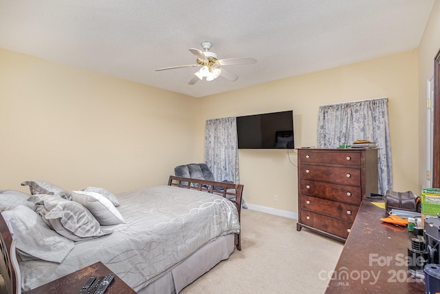 carpeted bedroom with a textured ceiling and ceiling fan