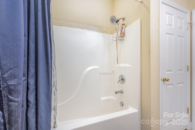 bathroom with shower / bath combo with shower curtain