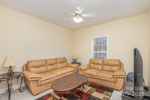 carpeted living room with a textured ceiling and ceiling fan