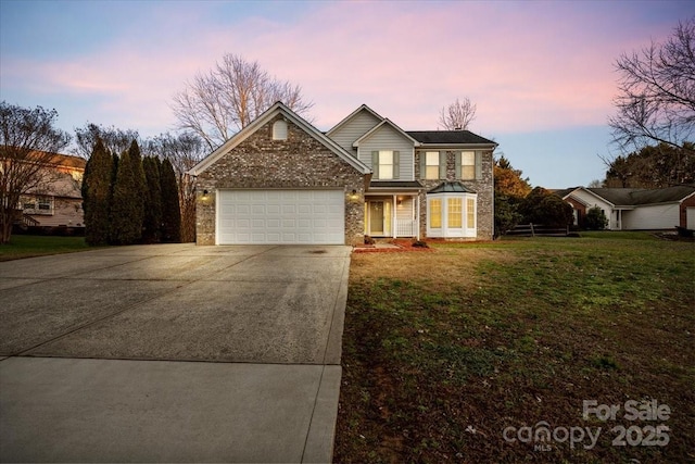 front facade featuring a yard and a garage