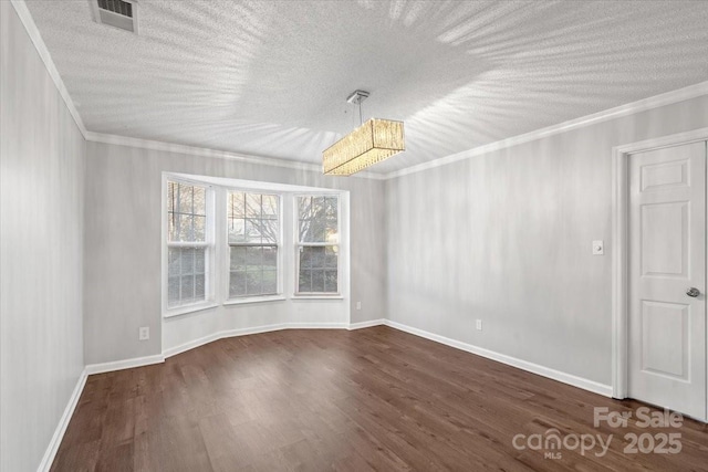 empty room featuring dark hardwood / wood-style floors, ornamental molding, and a textured ceiling